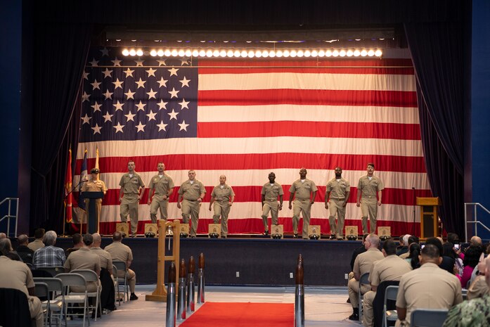 Chief petty officer selectees march on stage during a pinning ceremony at Naval Base Kitsap-Bremerton, Washington Sept. 29, 2023. The rank of chief petty officer was officially established April 1, 1893, and holding the title "Chief" means a Sailor has achieved senior non-commissioned officer status. (U.S. Navy photo by Mass Communication Specialist 3rd Class Sophia H. Bumps)