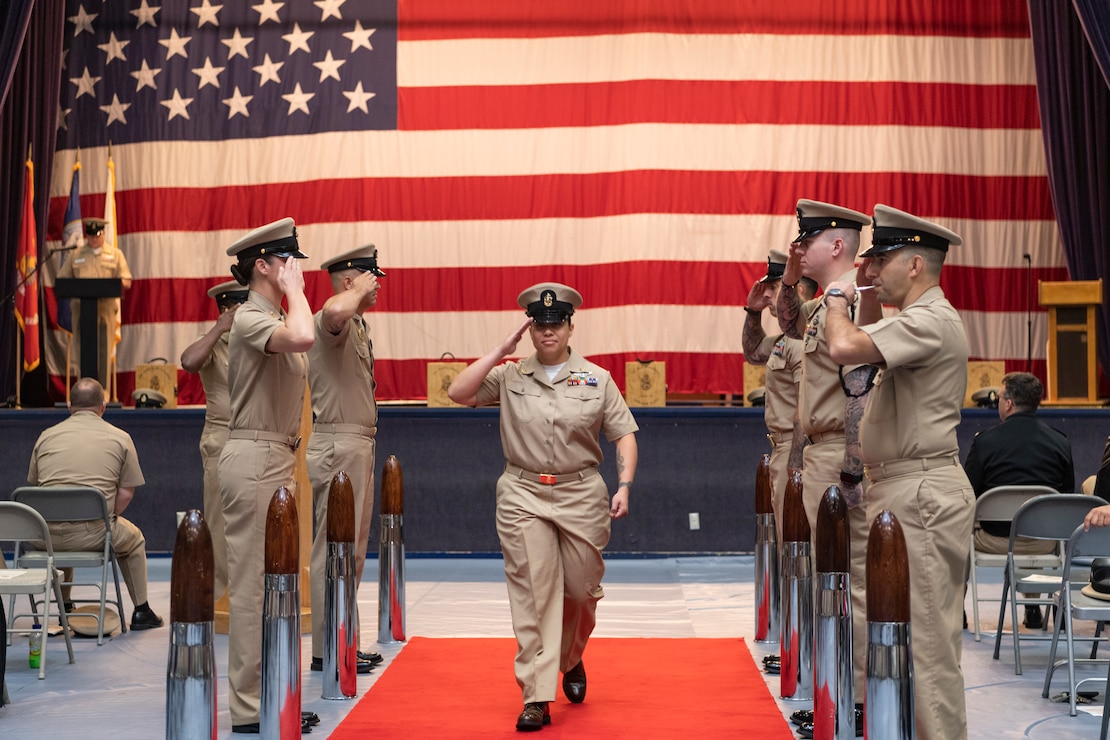 Chief Aviation Electronics Technician Tiyana Serrano walks through sideboys during a chief petty officer pinning ceremony at Naval Base Kitsap-Bremerton, Washington Sept. 29, 2023. The rank of chief petty officer was officially established April 1, 1893, and holding the title "Chief" means a Sailor has achieved senior non-commissioned officer status. (U.S. Navy photo by Mass Communication Specialist 3rd Class Sophia H. Bumps)