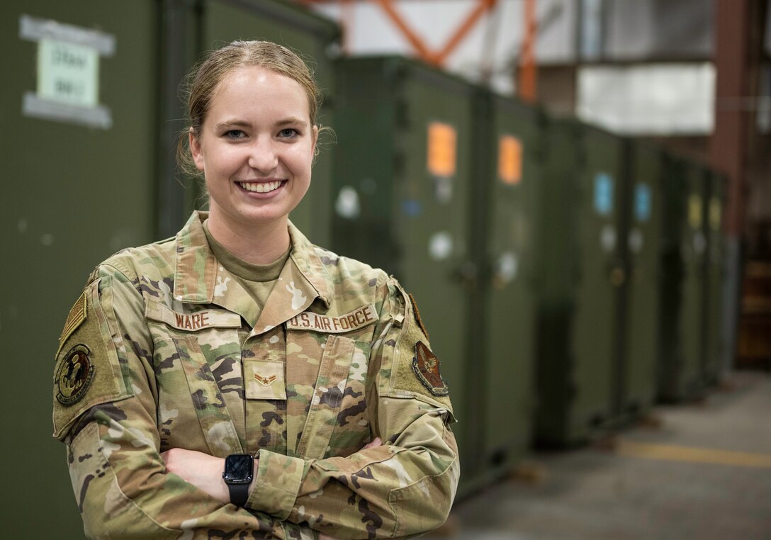 Airman 1st Class Emily Ware, 28th Logistics Readiness Squadron aircraft parts store technician, poses for a photo in the aircraft parts store warehouse on Ellsworth Air Force Base, South Dakota, Aug. 25, 2023.