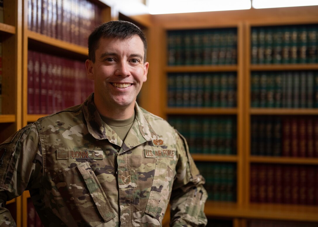 Tech. Sgt. Marcus Lonn, 28th Bomb Wing Legal Office Non-Commisioned Officer In Charge of military justice, poses for a photo in the legal office’s library at Ellsworth Air Force Base, South Dakota, Aug. 23, 2023.