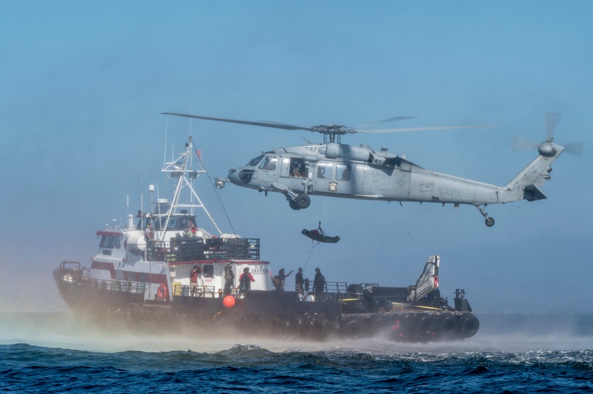 U.S. Airmen, training with the 68th Rescue Squadron, hoist a simulated casualty near San Diego, Calif., Sept. 6, 2023. The Airmen were required to exfiltrate several casualties in a short amount of time. (U.S. Air Force photo by Airman 1st  Class William Finn V)