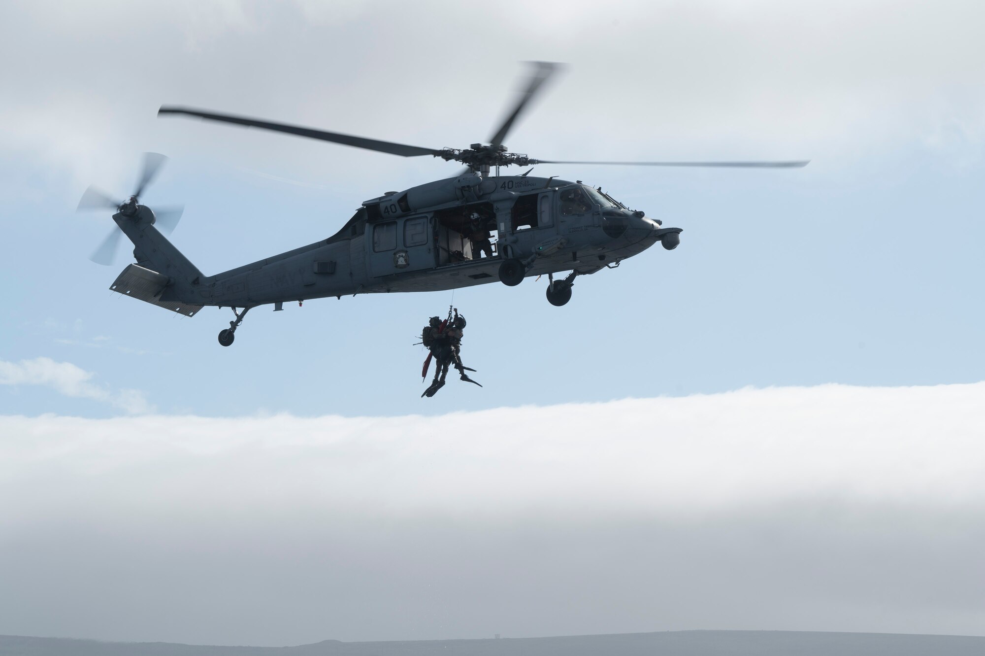 U.S. Airmen, training with the 68th Rescue Squadron, hoist into an aircraft off the coast of Calif., Sept. 12, 2023. The Airmen were required to assist several simulated casualties into the aircraft before boarding and taking the casualties to receive medical care. (U.S. Air Force photo by Airman 1st Class William Finn V)