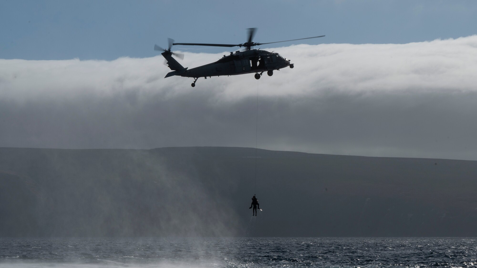 A U.S. Airman, training with the 68th Rescue Squadron, hoists a simulated casualty into an aircraft off the coast of Calif., Sept. 12, 2023. During the training The Airman was required to load multiple casualties from the water onto the aircraft. (U.S. Air Force photo by Airman 1st Class William Finn V)