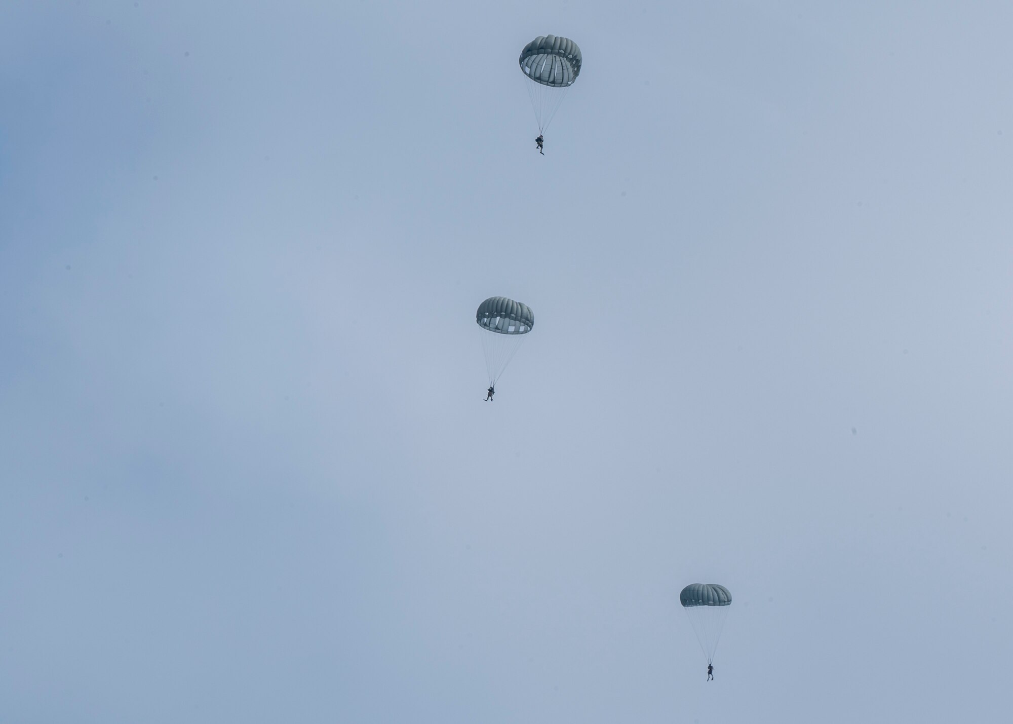 U.S. Airmen, training with the 68th Rescue Squadron, parachute into the ocean off the coast of Calif., Sept. 12, 2023. The Airmen parachuted down to the water, located simulated casualties aboard a boat, provided the casualties with medical care, and engaged with simulated opposition forces. (U.S. Air Force photo by Airman 1st Class William Finn V)