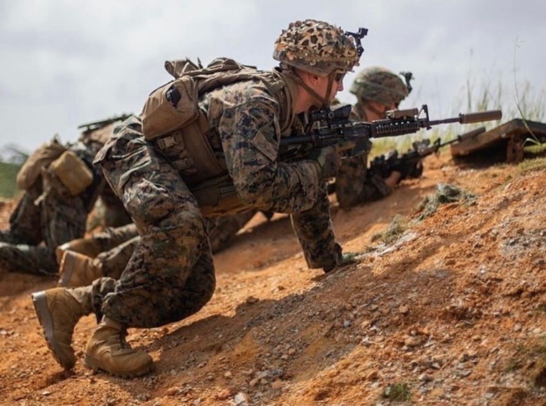 Cpl. Nicholas Christensen executes infantry maneuvers during a training exercise in Okinawa, Japan. Christensen, a native of St. Charles, Ill. a machine gunner, provided lifesaving medical care to a gravely injured Marine after a vehicle collision in Oceanside, Calif., September 2023. (Department of Defense photo)