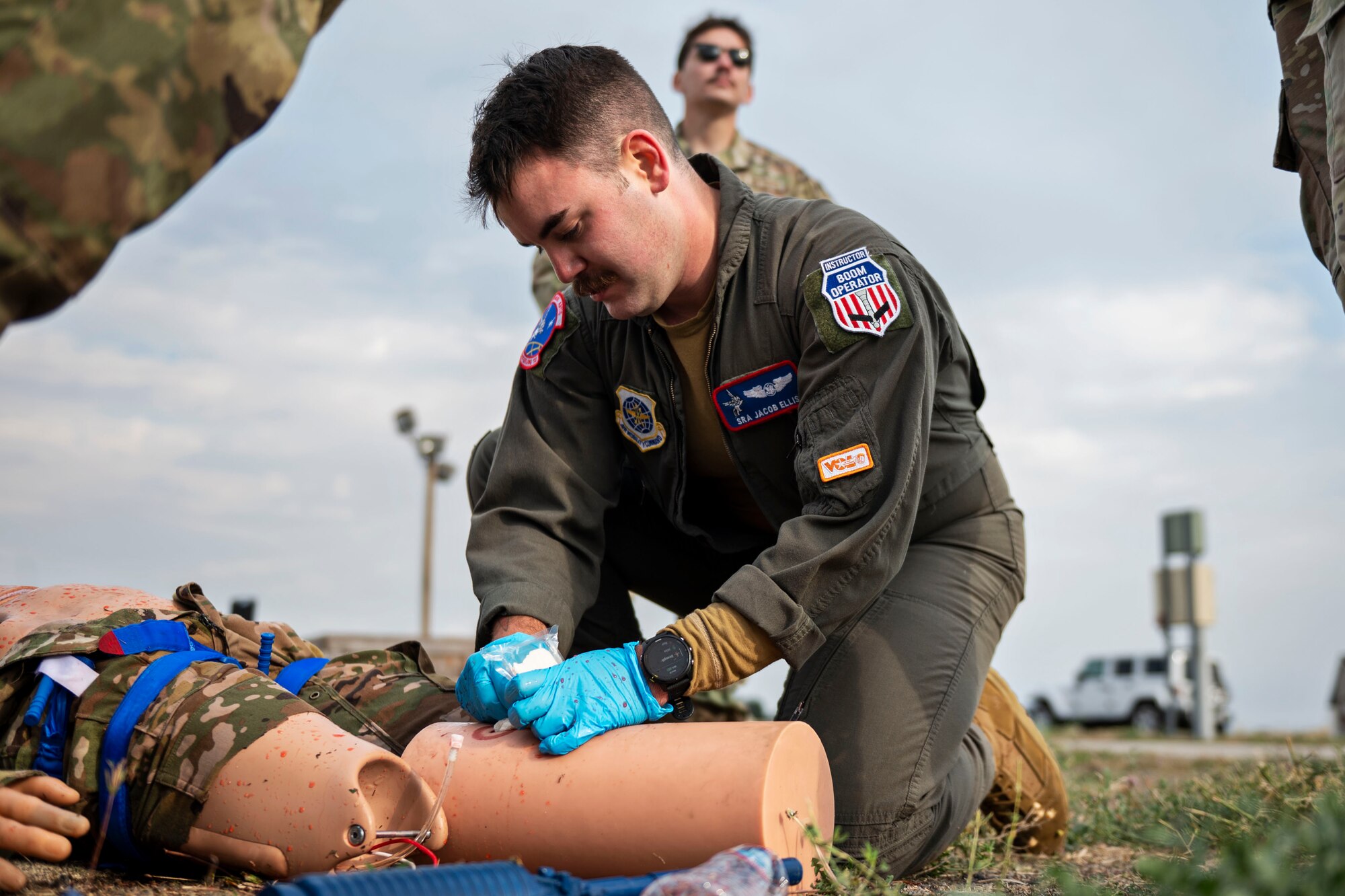 Senior Airman Jacob Ellis, an in-flight refueling specialist assigned to the 93rd Air Refueling Squadron, treats a simulated casualty during a “boom rodeo" hosted by the 92nd Operations Group at Fairchild Air Force Base, Washington, Sept. 20, 2023. During the rodeo, six air refueling squadrons competed in a forklift loading event, Tactical Combat Casualty Care and a water survival scenario. Scenarios like this enable Airmen to get hands-on training with tools to which they may not otherwise have access. These competitions also build camaraderie between units from different bases and provide friendly competition to motivate Airmen to perform their best. (U.S. Air Force photo by Airman 1st Class Morgan Dailey)