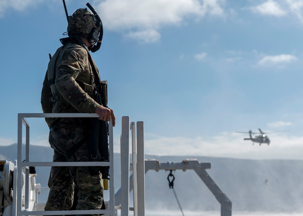 A U.S. Airman, training with the 68th Rescue Squadron, manages his team during a simulated rescue operation off the coast of Calif., Sept. 13, 2023. The Airman communicated with aircraft pilots, members of his team and simulated casualties to ensure a successful rescue and exfiltration. (U.S. Air Force photo by Airman 1st Class William Finn V)