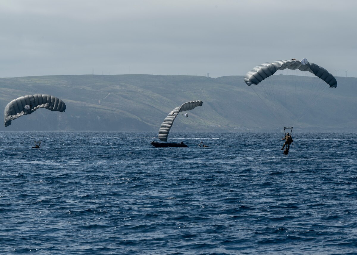 U.S. Airmen, training with the 68th Rescue Squadron, parachute into a drop zone off the coast of Calif., Sept. 13, 2023. The Airmen jumped into the drop zone in two groupings of members, before boarding a Rigged Alternate Method Boat. (U.S. Air Force photo by Airman 1st Class William Finn V)
