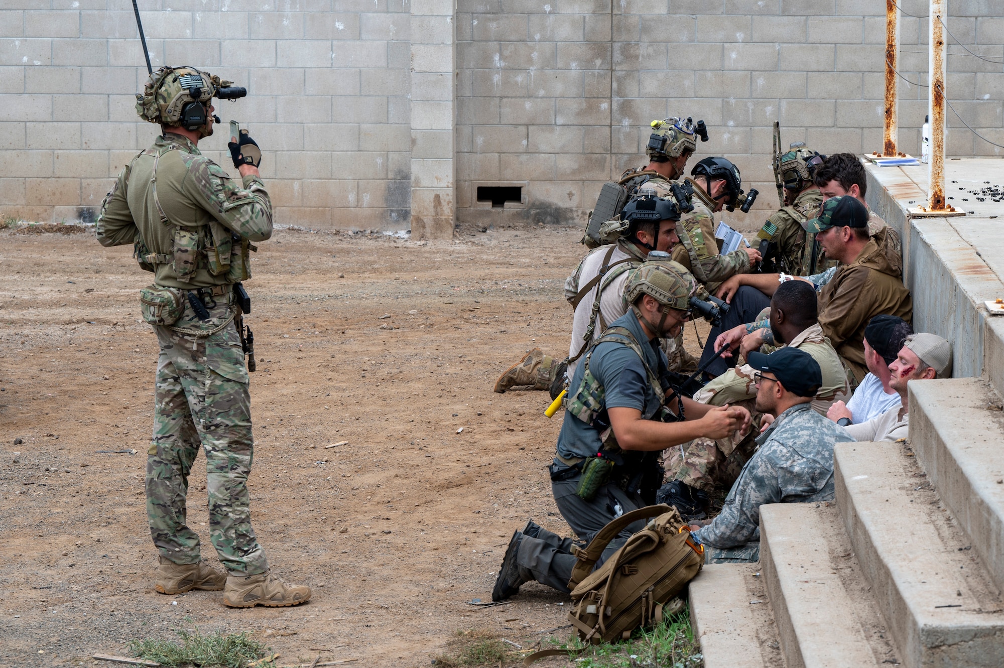 U.S. Airmen, training with the 68th Rescue Squadron, tend to simulated casualties at an UNDISCLOSED LOCATION, Calif., Sept. 17, 2023. The Airmen were required to locate the casualties inside a variety of buildings and bring them to a central point for treatment before exfiltrating them. (U.S. Air Force photo by Airman 1st Class William Finn V)
