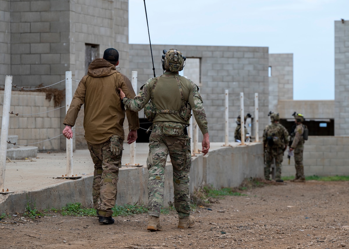 A U.S. Airman, training with the 68th Rescue Squadron, escorts a simulated casualty at an UNDISCLOSED LOCATION, Calif., Sept. 17, 2023. The Airmen lead the casualty back to his team for evaluation and treatment . (U.S. Air Force photo by Airman 1st Class William Finn V)