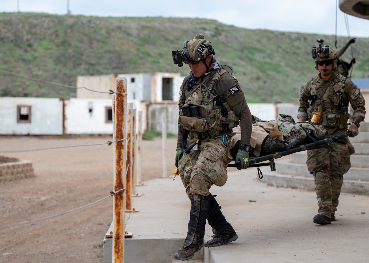 U.S. Airmen, training with the 68th Rescue Squadron, carry a simulated casualty at an UNDISCLOSED LOCATION, Callif., Sept. 17, 2023. The Airmen were required to locate, treat and exfiltrate over 30 simulated casualties. (U.S. Air Force photo by Airman 1st Class William Finn V)