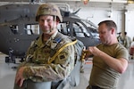 Nebraska Army National Guard Staff Sgt. Kevin Nelson, right, assistant jumpmaster, inspects a parachute worn by Capt. Ben Jochum, 2-134th Infantry Battalion (Airborne) logistics officer, in preparation for a static line jump Sept. 29, 2023, in Lincoln, Neb. Twenty-eight paratroopers of the Nebraska Army National Guard's 2-134th Infantry Battalion (Airborne) completed the jump from a C-17 Globemaster III assigned to the Alaska Air National Guard's 144th Airlift Squadron, 176th Wing.
