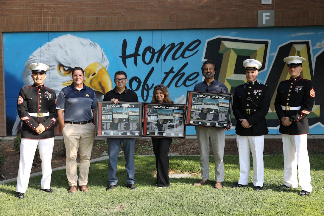 U.S. Marine Corps 1st Lt. Mitchell Teefey, the executive officer of Recruiting Station Sacramento, and recruiters with Recruiting Substation Modesto, Recruiting Station Sacramento, present Albert Quintero, Emma Johnson, and Gurpinder Basra, Educators’ Workshop awards at James C. Enochs High School in Modesto, Calif. on Sept 21, 2023. The Educators' Workshop is a five-day program designed to better inform teachers, coaches, counselors and influencers about the benefits, and opportunities available during service in the Marine Corps. This allows attendees to return home and provide first-hand experience and knowledge to individuals interested in military service. (U.S. Marine Corps photo by Sgt. Seaira Moore)