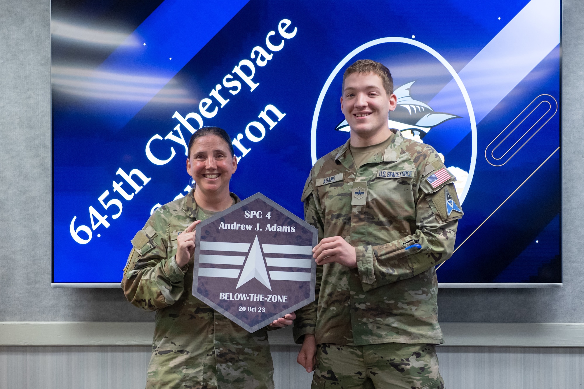 U.S. Space Force Chief Master Sgt. Susan Sparks, SLD 45 Senior Enlisted Leader and U.S. Space Force Specialist 3 Andrew Adams, 645th Cyberspace Squadron defensive cyber operator, poses for a photo at Patrick Space Force Base, Florida, Oct. 2, 2023. Specialist Adams was selected for Below-the-Zone, a competitive selection that allows those with the rank of Airman 1st Class/Specialist 3 to achieve Senior Airman/Specialist 4, six months ahead of the standard promotion date. (U.S. Space Force photo by DeAnna Murano)
