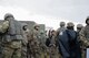 Airmen assigned to the 5th Civil Engineer Squadron (CES) gather to be issued weapons and complete accountability at Douglass Creek campgrounds, North Dakota, Sept. 23, 2023. 5th CES Airmen participated in an Agile Combat Employment exercise which tested their survival tactics.