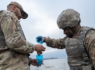 Airmen with the 5th Civil Engineer Squadron work as a team to collect and filter water at Douglass Creek campgrounds, North Dakota, Sept. 23, 2023. The Airmen came together for an Agile Combat Employment exercise that tested their understanding of survival tactics.