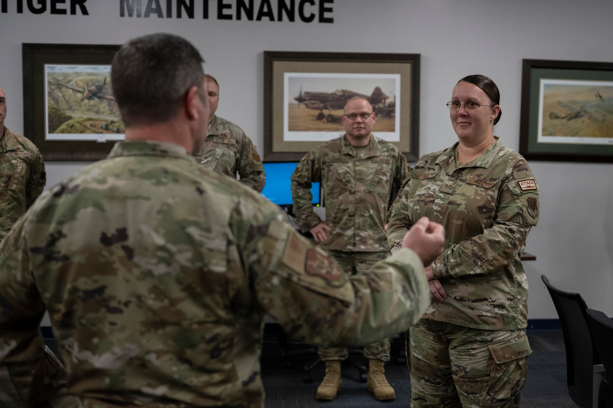 The wing commander talks to Airmen
