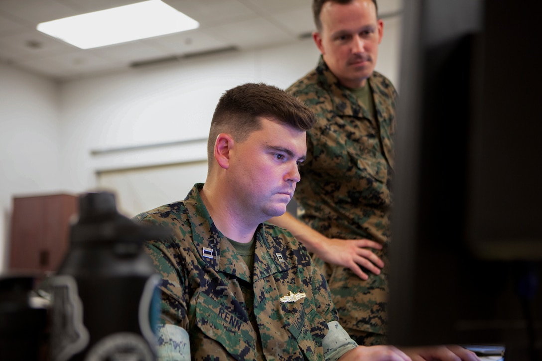 U.S. Navy Lt. Tyler Renn, a Madison, Alaska native and naval integration officer with 2d Marine Division reviews documents for a Joint Task Force Exercise (JTFEX) on Camp Lejeune, North Carolina, September 13, 2023. 2d MARDIV Headquarters Battalion held the JTFEX to promote mission readiness and support for future deployments. (U.S. Marine Corps photo by Lance Cpl. Kylie Lake)