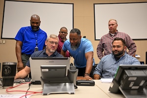 A photo of people working together at the Emerald Warrior exercise.