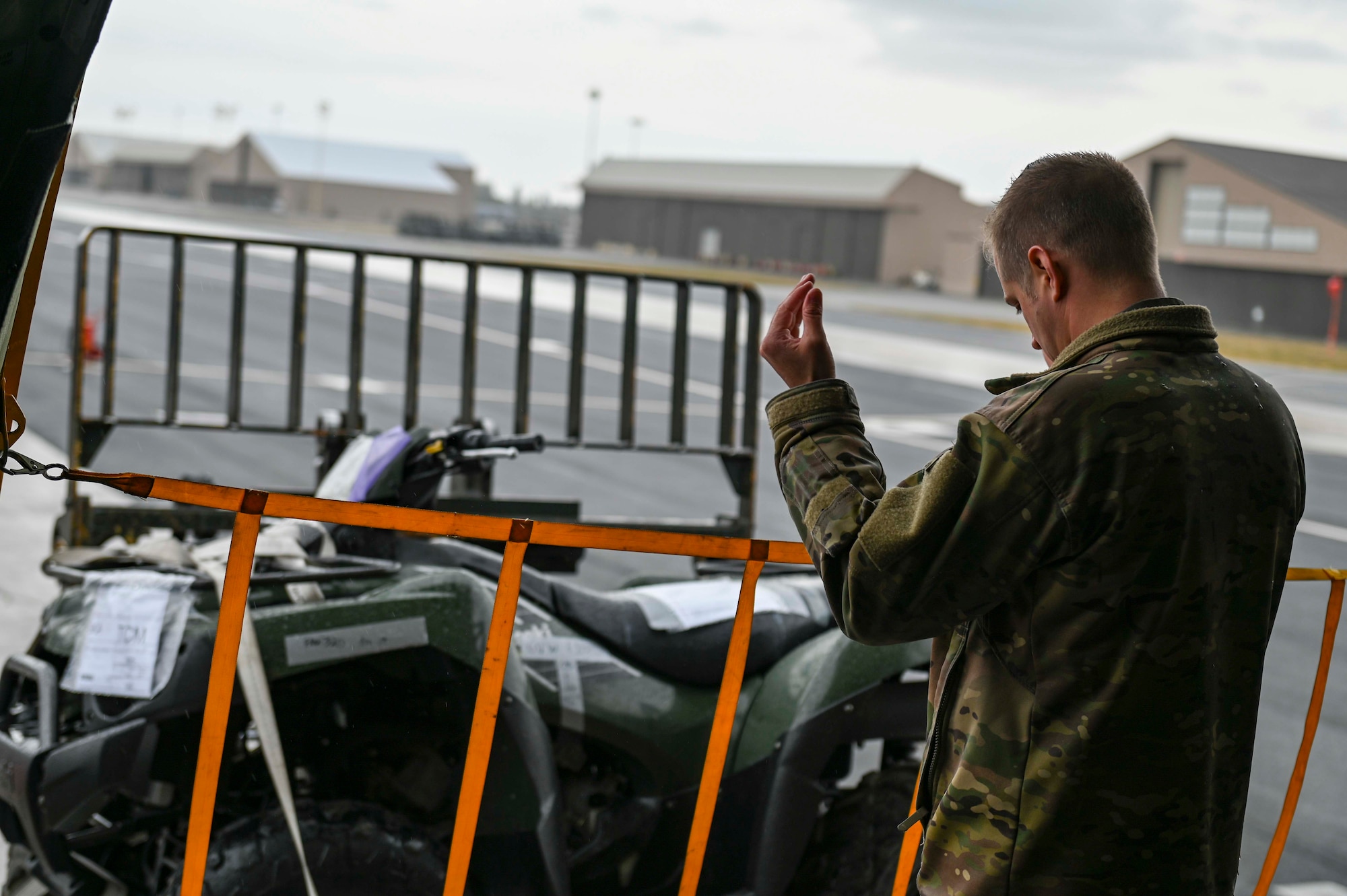 An Airman marshals a forklift while inside of the cargo area on the KC-135 Stratotanker
