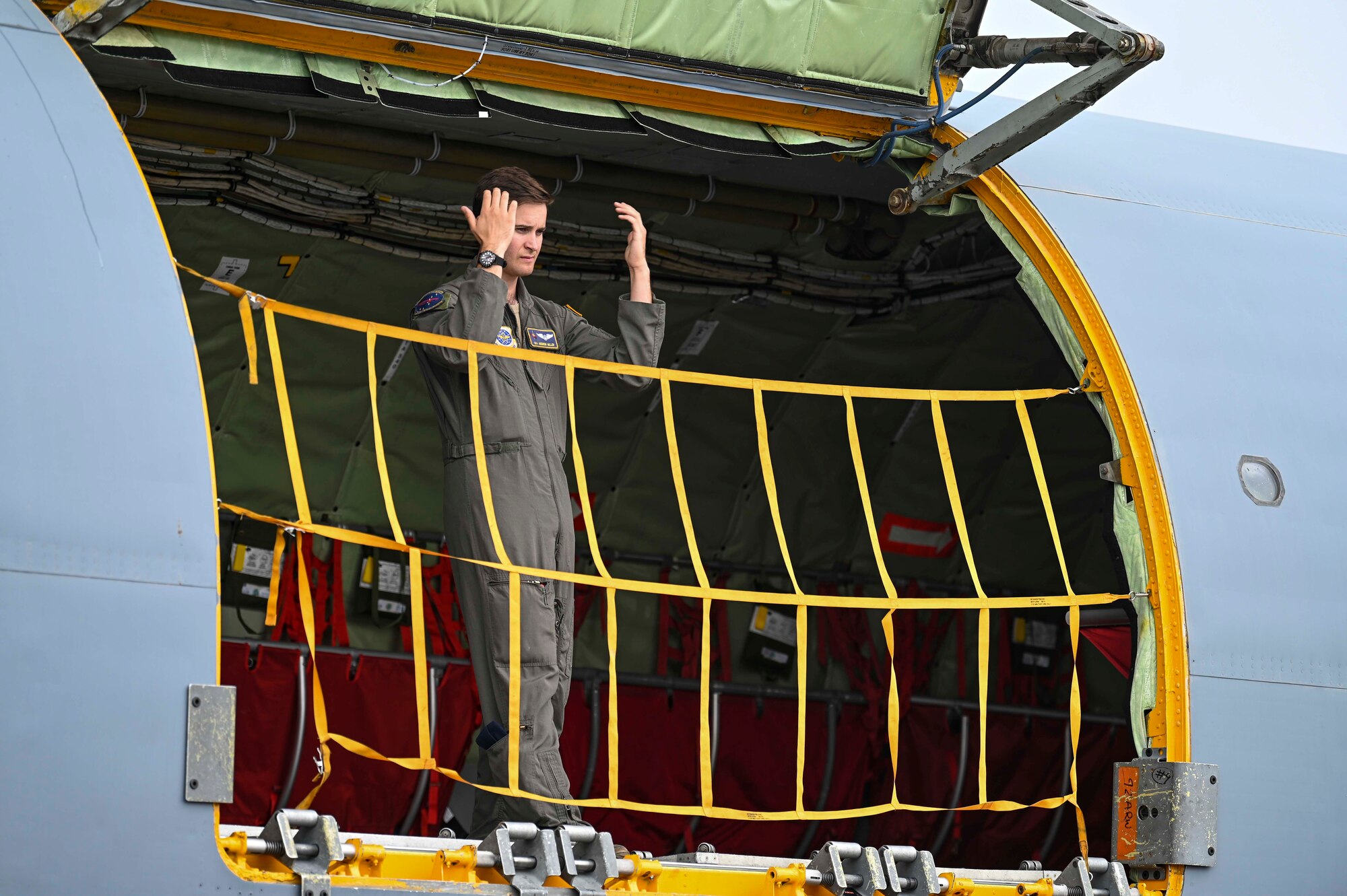 An Airman marshals from inside of a KC-135 Stratotanker