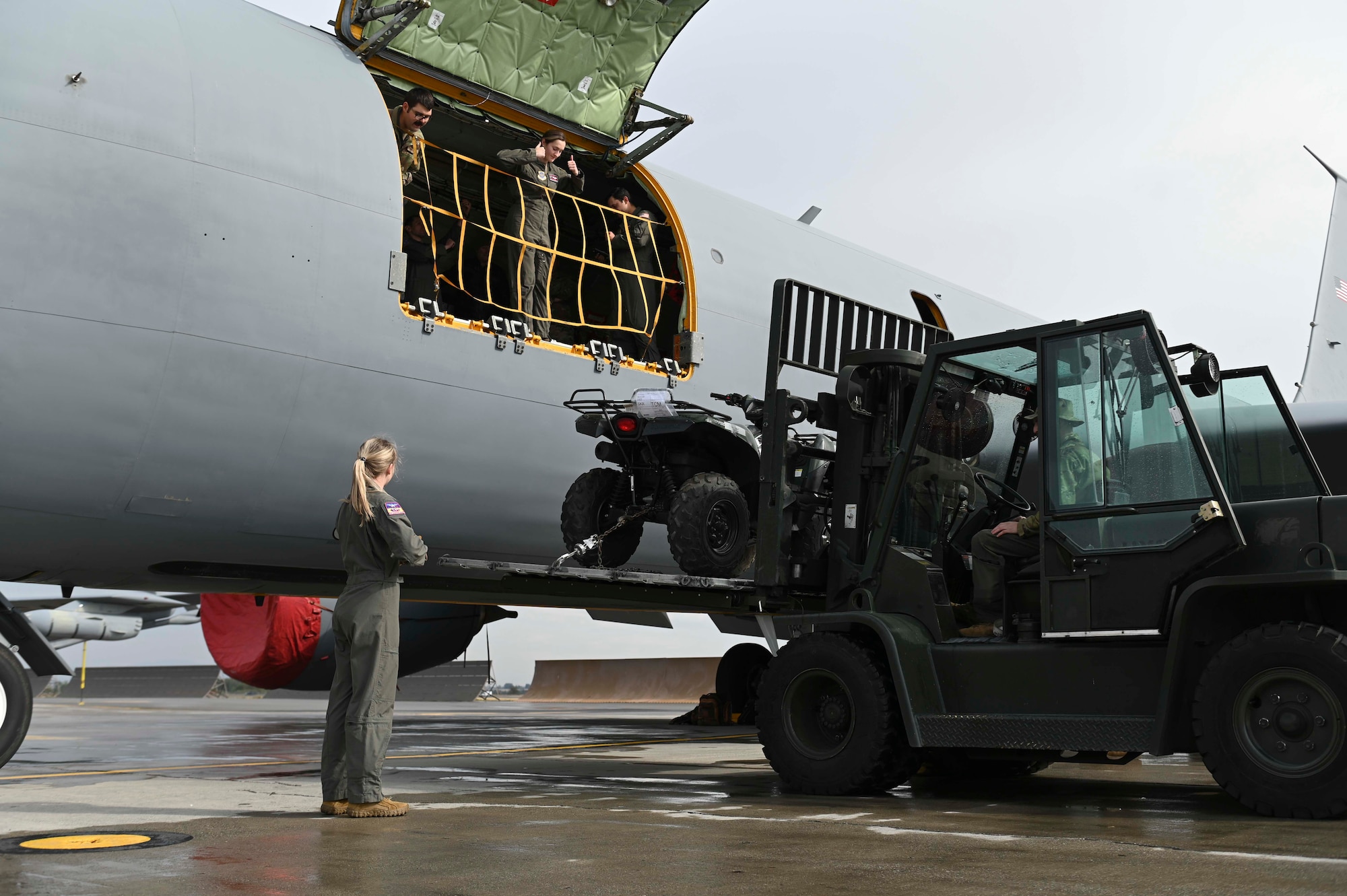 Airmen use a forklift to lift cargo into a KC-135 Stratotanker