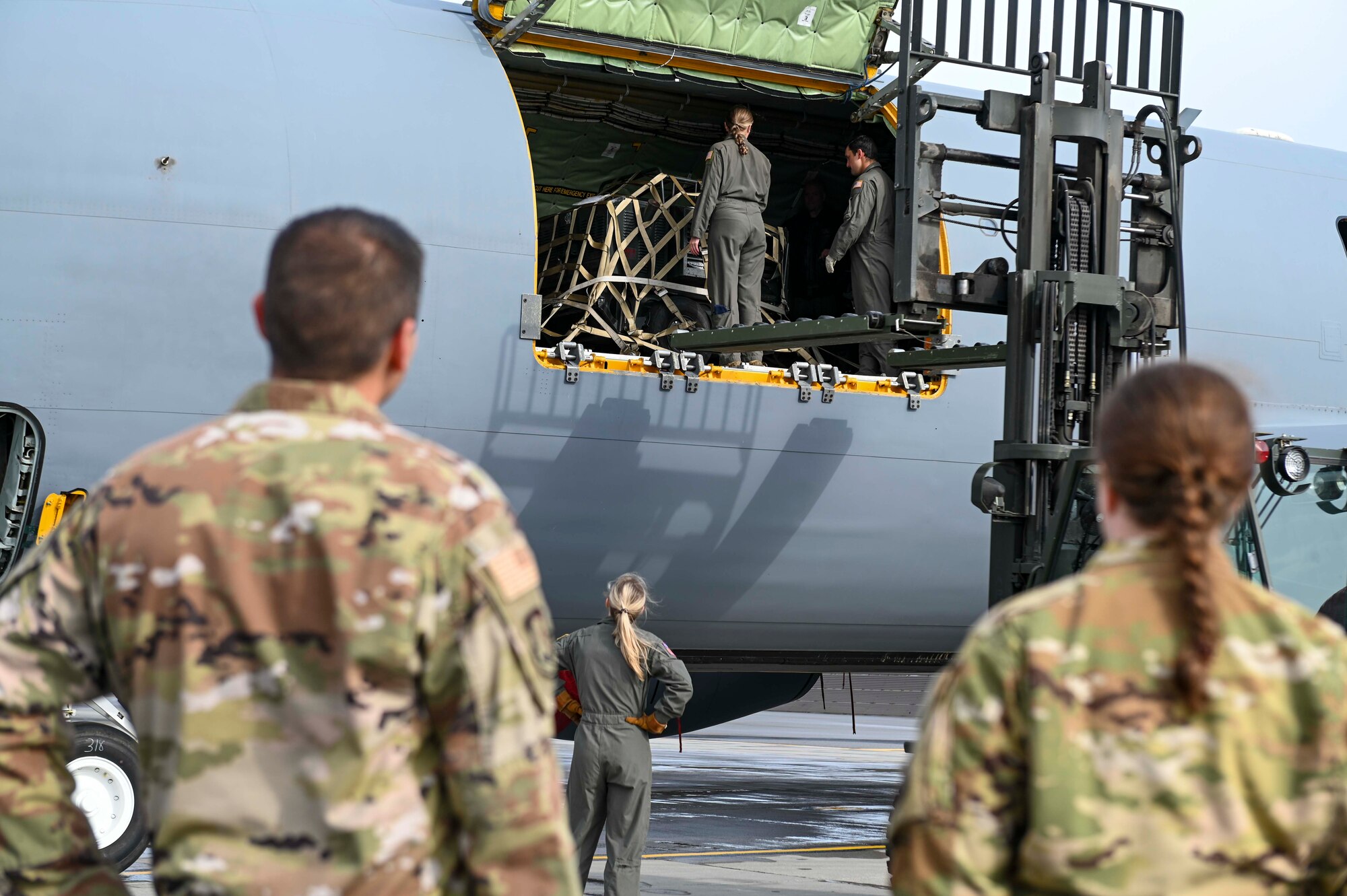 Members of the 384th Wing leadership watch Airmen from the 384th load cargo into a KC-135 Stratotanker