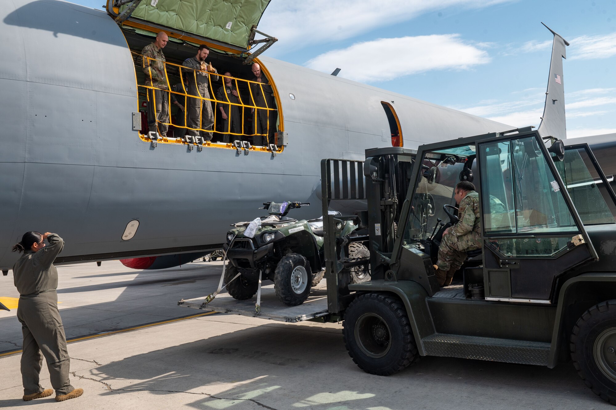 Airmen use a forklift to load cargo into a KC-135 Stratotanker.