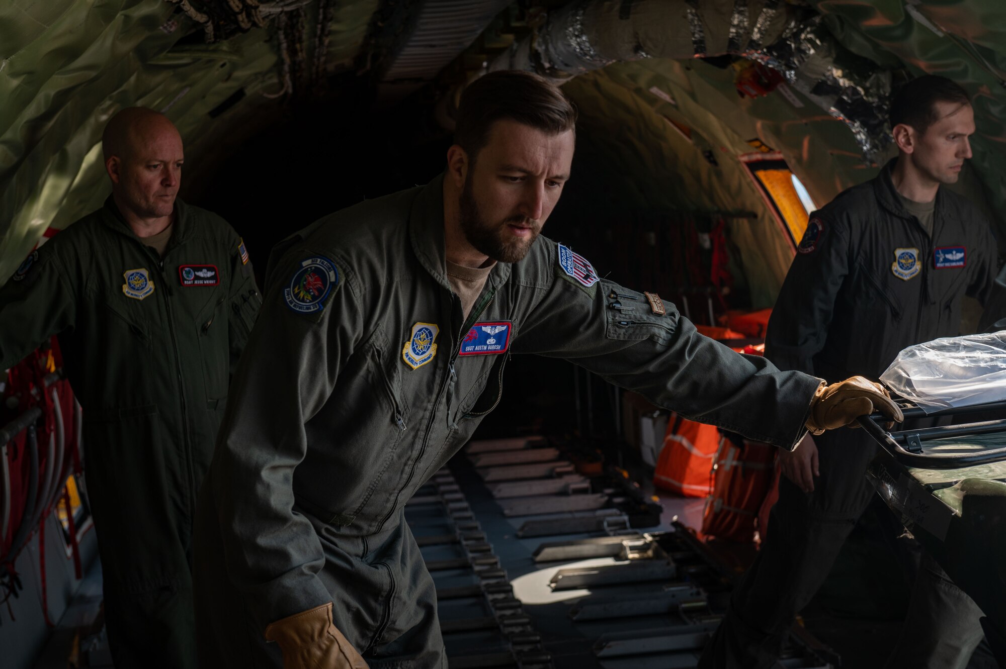 Airman pushes cargo out of a KC-135 Stratotanker.