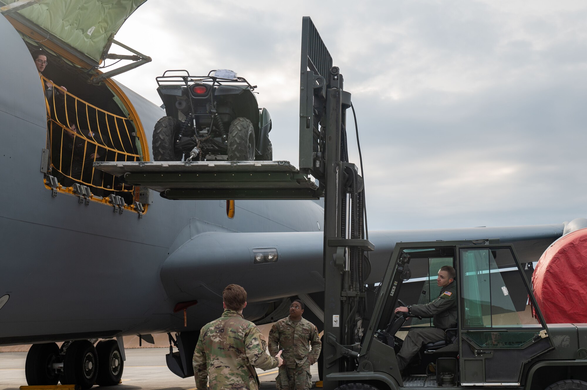 Airmen load cargo into a KC-135 Stratotanker with a forklift.