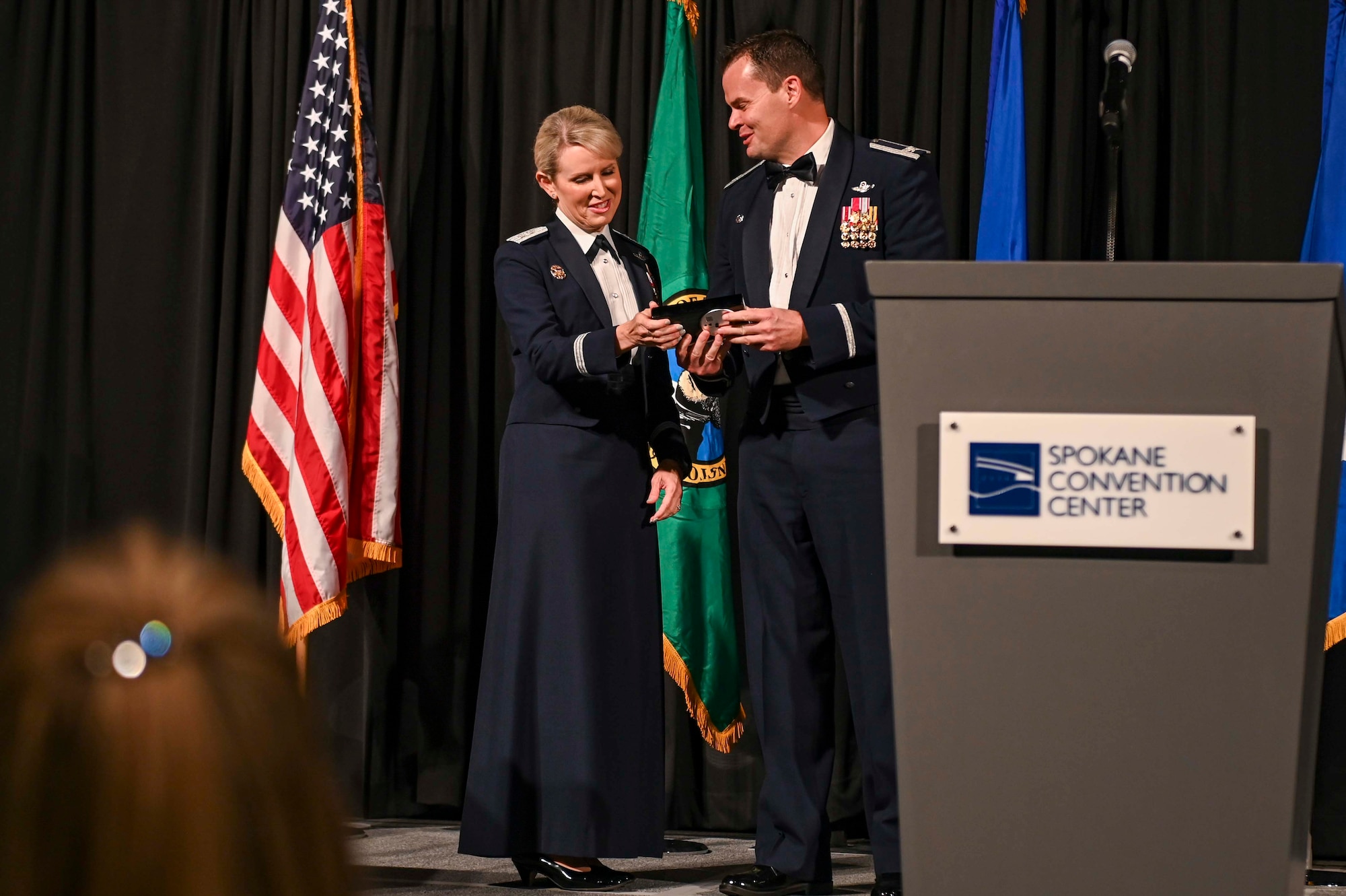 Col. Chesley Dycus hands an award to Maj. Gen. Laura Lenderman