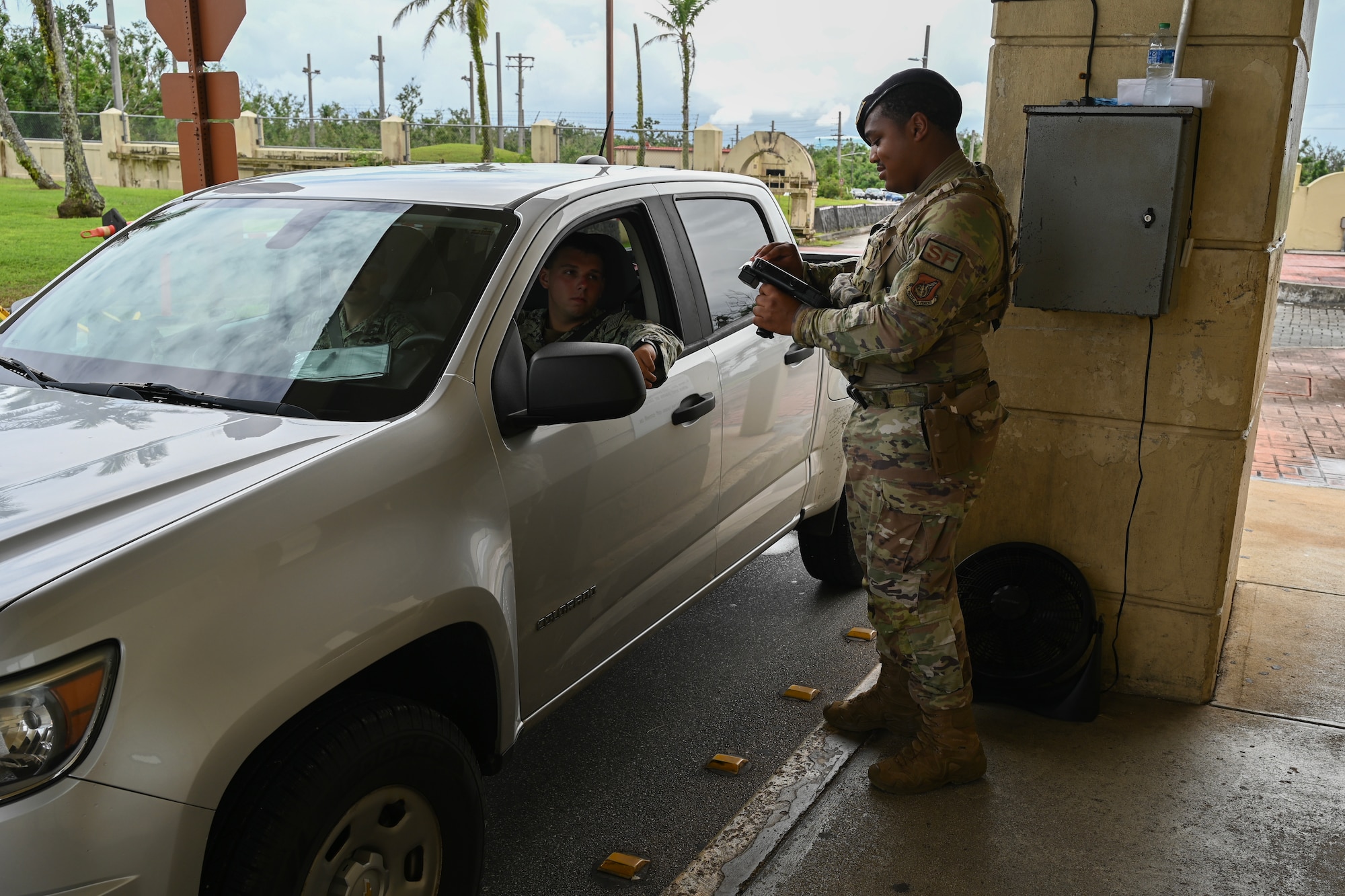 A patrolman scans a common access card with his scanner.