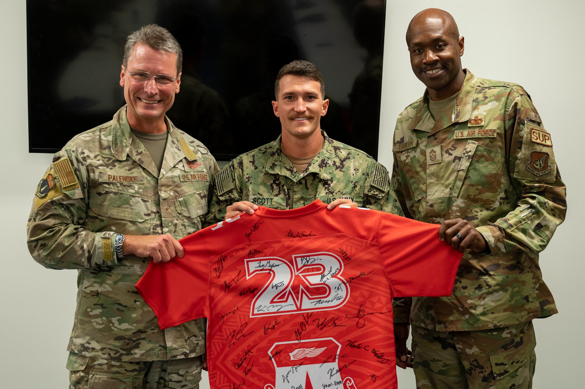 U.S. Navy Petty Officer 2nd Class Kaimi Scott, an aviation electronics technician assigned to the Unmanned Patrol Squadron (VUP) 19, receives the Linebacker of the Week Award from U.S. Air Force Brig. Gen. Thomas Palenske, commander of the 36th Wing, and U.S. Air Force Chief Master Sgt. Nicholas Taylor, the command chief of the 36th Wing, at Andersen Air Force Base, Guam, Sept. 27, 2023. The Team Andersen Linebacker of the Week recognizes outstanding enlisted, officer, civilian and total force personnel who have had an impact on achieving Team Andersen’s mission, vision and priorities. (U.S. Air Force photo by Airman 1st Class Emily Saxton)