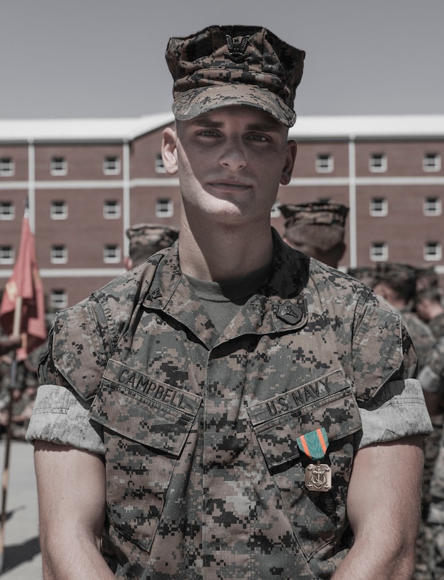 U.S. Navy Petty Officer 3rd Class Clay Campbell, a field medical technician with 2d Battalion, 8th Marine Regiment, 2d Marine Division, poses for a photo on Camp Lejeune, North Carolina, September 15, 2023. Campbell was awarded and recognized for providing medical care to a young woman having a seizure until medics arrived on scene, ultimately saving her life. (U.S. Marine Corps photo illustration by Cpl. Megan Ozaki)