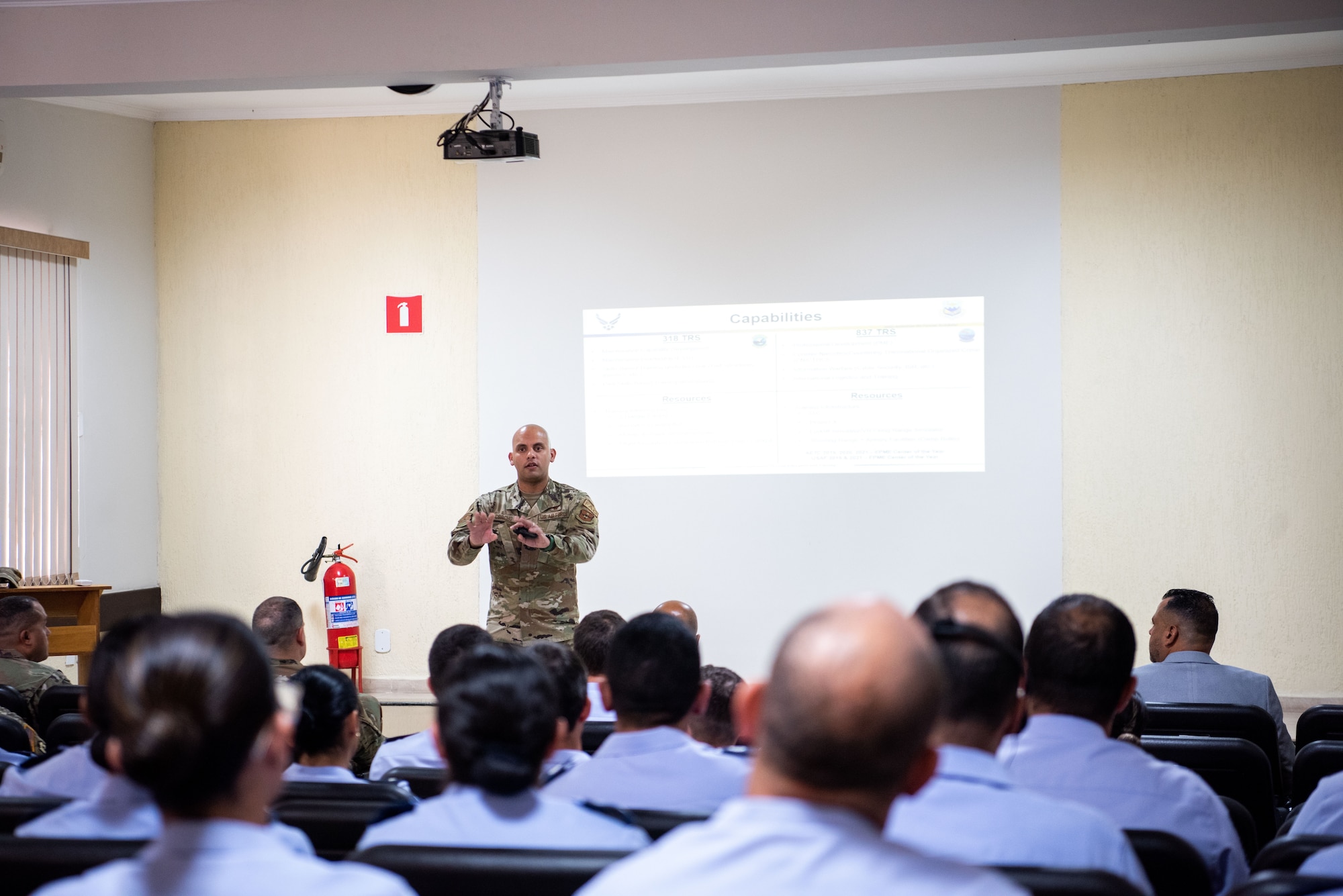 Maj. Elias Corcho, Director of Operations, of the 837th Training Squadron, gestures with his hands during a briefing at the Aeronautics Specialist School in Sao Paolo, Brazil, Aug. 22, 2023. The Inter-American Air Forces Academy led the professional development subject matter expert exchange with the Brazilian Air Force. It was the first visit of its kind in over a decade. (U.S. Air Force photo by Vanessa R. Adame)