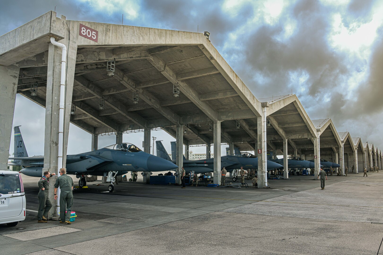 Airmen from the 104th Fighter Wing complete post flight checks on four F-15C Eagles.