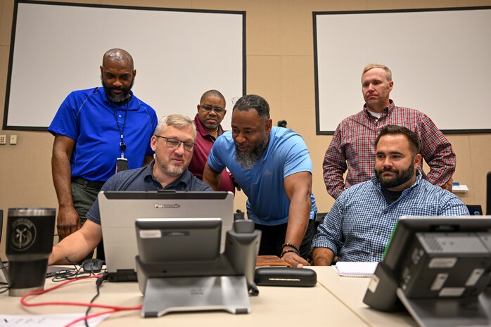 A photo of people working together at the Emerald Warrior exercise.