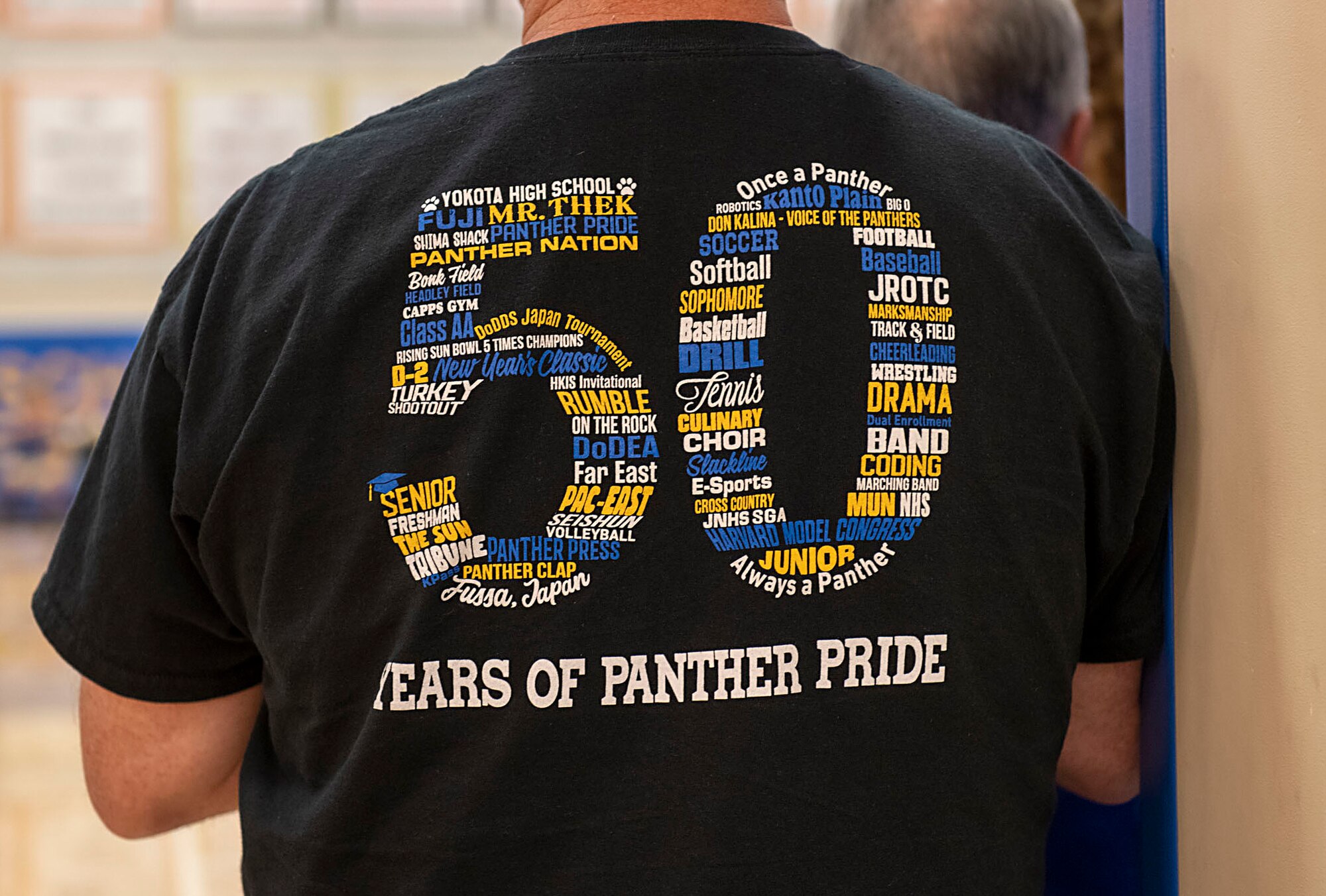 A Yokota High School alumni wears a 50th Anniversary shirt titled “50 years of Panther Pride”
