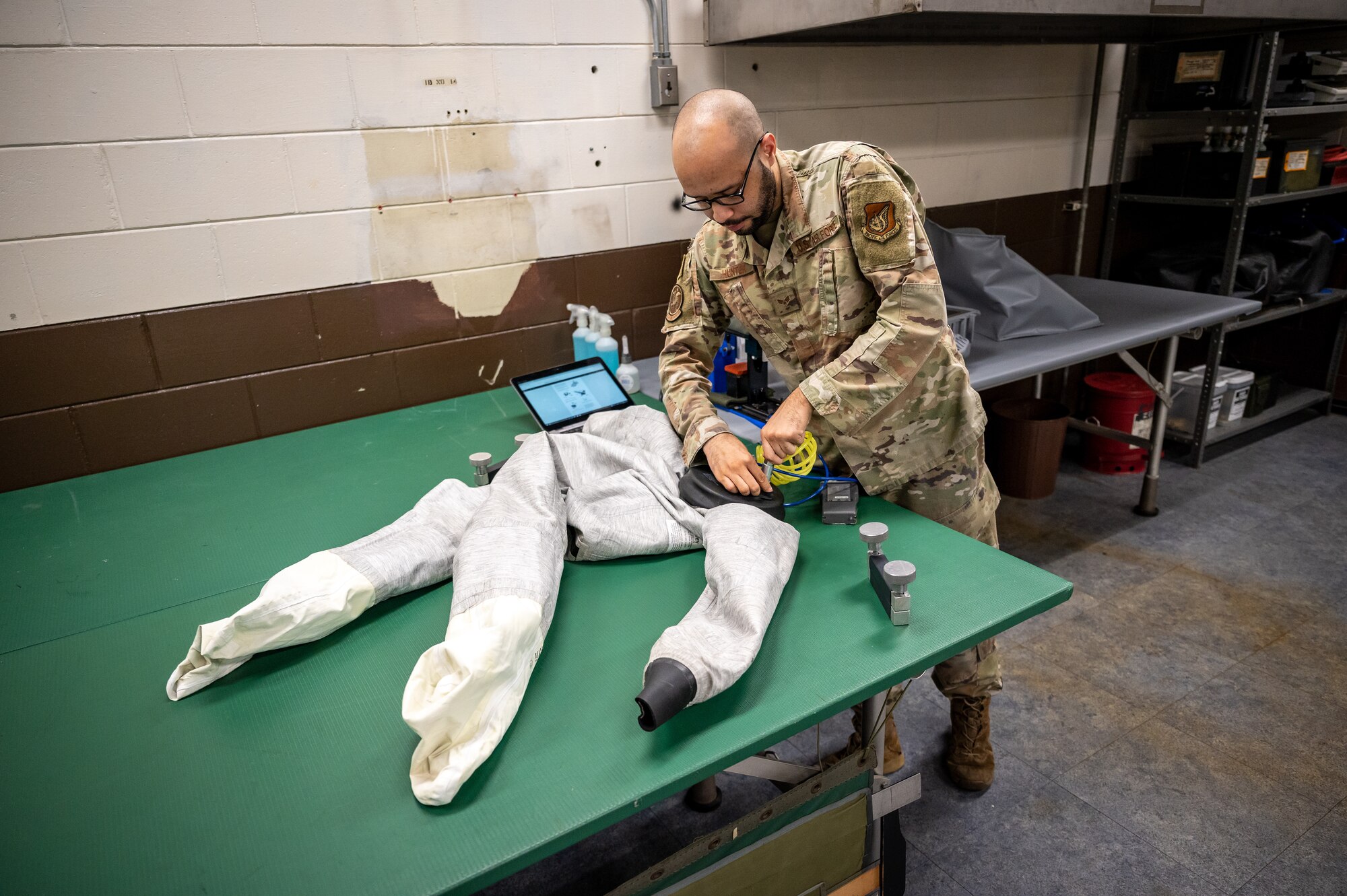 U.S. Air Force Senior Airman James Hunter, 51st Operations Support Squadron aircrew flight equipment journeyman, conducts a routine inspection on an over-the-side flight suit at Osan Air Base, Republic of Korea, Sept. 25, 2023. An OTS suit is used during the winter months to keep pilots dry and warm in the case of an ejection. AFE specialists conduct routine inspections and maintenance on flight equipment to ensure the 25th and 36th Fighter Squadrons are always primed and ready to carry out the fight tonight mission. (U.S. Air Force photo by Staff Sgt. Thomas Sjoberg)