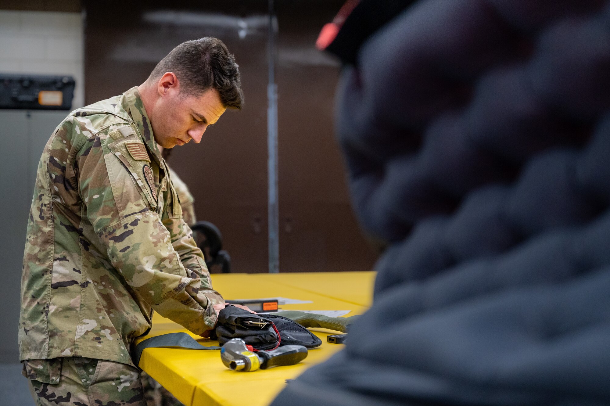U.S. Air Force Senior Airman Aaron Cusick, 51st Operations Support Squadron aircrew flight equipment journeyman, conducts a routine inspection on a life preserver unit at Osan Air Base, Republic of Korea, Sept. 25, 2023. AFE specialists are dedicated to ensuring flight equipment remains consistently reliable as they are a critical factor in upholding safe flight operations during mission execution within the 51st Fighter Wing. (U.S. Air Force photo by Staff Sgt. Thomas Sjoberg)