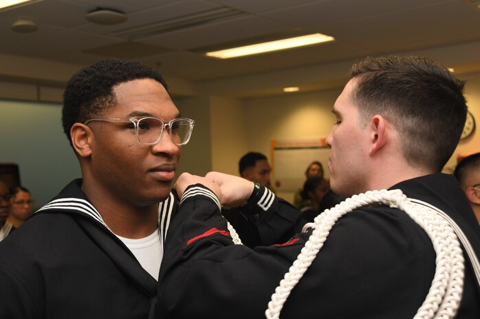 230926-N-FB730-1007 CAMP LEJEUNE (Sept. 26, 2023) A Sailor in the Naval Medical Center Camp Lejeune honor guard is pinned with his ropes during a rope ceremony in the medical center on Sept. 26, 2023. (Photo by Mass Communication Specialist 2nd class Justin Woods)