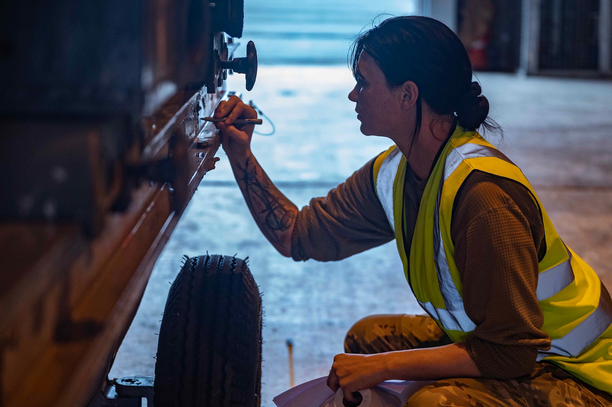 U.S. Air Force Staff Sgt. Recebba Frazier, 727th Air Mobility Squadron Air Transportation Function non-commissioned officer in charge, marks the center of the engine transport stand at Royal Air Force Mildenhall, England, Oct. 3, 2023. The cargo deployment flight prepared mobility cargo prior to a joint inspection in support of Cobra Warrior 23 Part 2, protecting USAF assets, personnel, and maintaining a ready force. (U.S. Air Force photo by Senior Airman Viviam Chiu)