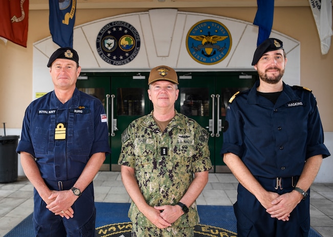 Royal Navy Vice Adm. Andrew Burns OBE, left, fleet commander of the Royal Navy, meets with Vice Adm. Thomas Ishee, center, commander of U.S. 6th Fleet, in front of the U.S. Naval Forces Europe-Africa (NAVEUR-NAVAF) and U.S. 6th Fleet headquarters on Naval Support Activity Naples, Italy, Oct. 4, 2023. NAVEUR-NAVAF operates U.S. naval forces in the U.S. European Command (USEUCOM) and U.S. Africa Command (USAFRICOM) areas of responsibility. U.S. 6th Fleet is permanently assigned to NAVEUR-NAVAF, and employs maritime forces through the full spectrum of joint and naval operations. (U.S. Navy photo by Mass Communication Specialist 1st Class Cameron C. Edy)