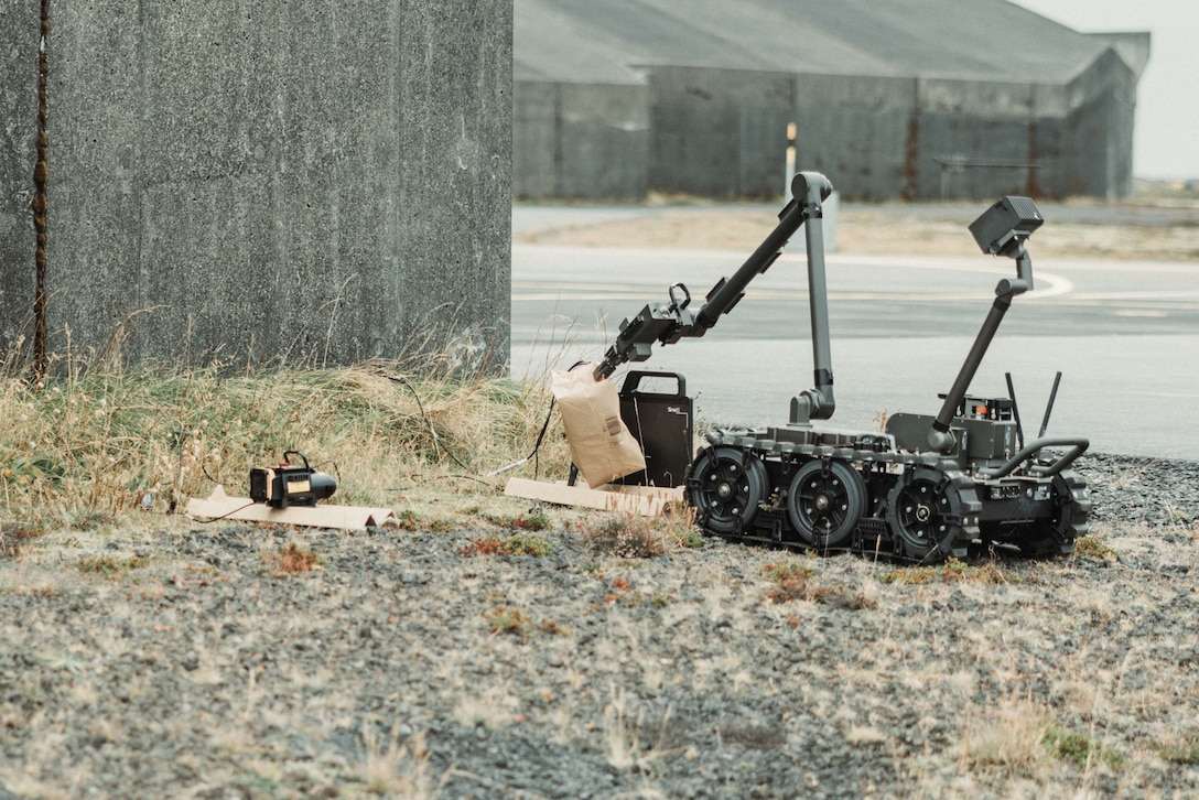 A U.S. Marine Corps Remote Controlled Man Transportable Robotic System Increment II places a simulated improvised explosive device in position for an x-ray during Exercise Northern Challenge 2023, Keflavik Airport, Iceland, Sept. 24, 2023. Northern Challenge 23 is an Icelandic Coast Guard-led bomb disposal exercise, hosted to train teams from over a dozen nations with response to incidents involving improvised and military explosive devices. The San Antonio-class amphibious transport dock ship USS Mesa Verde , assigned to the Bataan Amphibious Ready Group and embarked 26th Marine Expeditionary Unit, under the command and control of Task Force 61/2, is on a scheduled deployment in the U.S. Naval Forces Europe area of operations, employed by U.S. Sixth Fleet to defend U.S., Allied, and partner interests.