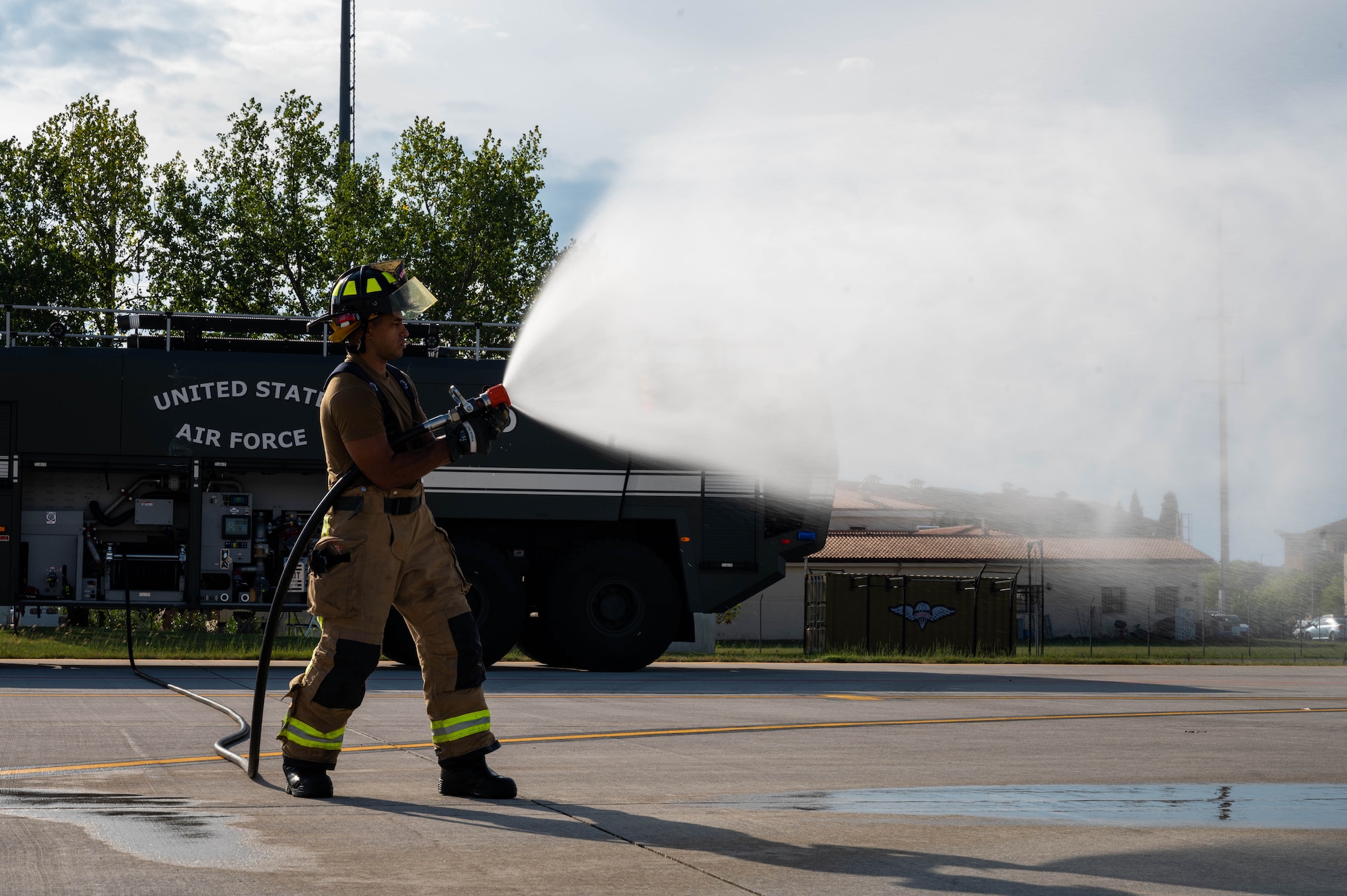 Senior Airman Cash sprays water from a hose.