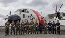 Members from the U.S. Coast Guard, Fisheries Agency of Japan, and Korea Coast Guard pose for a photo in front of a USCG HC-130J Super Hercules (Tail Number CG-2005) at Yokota Air Base, Japan, Sept. 22, 2023.