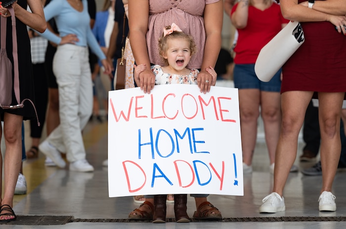 Airmen are welcomed home from deployment by family and friends on the flight line