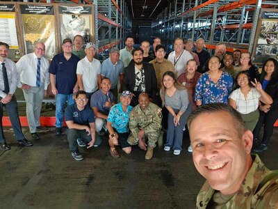 Col. Marc Welde, commander of U.S. Army Medical Logistics Command, takes a selfie photo with team members at the U.S. Army Medical Materiel Agency’s Medical Maintenance Operations Division in Tracy, California, during a recent site visit. Also pictured from the AMLC command team is Sgt. Maj. Akram Shaheed, background center. (Courtesy)