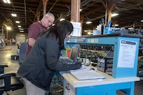 Sandhya Suresh, a civilian biomedical equipment technician, works alongside a teammate at the U.S. Army Medical Materiel Agency’s Medical Maintenance Operations Division at Tracy, California. The facility has embraced the “Together, Everyone Achieves More,” or T.E.A.M., philosophy and it’s been paying dividends throughout the workforce. (Katie Ellis-Warfield)