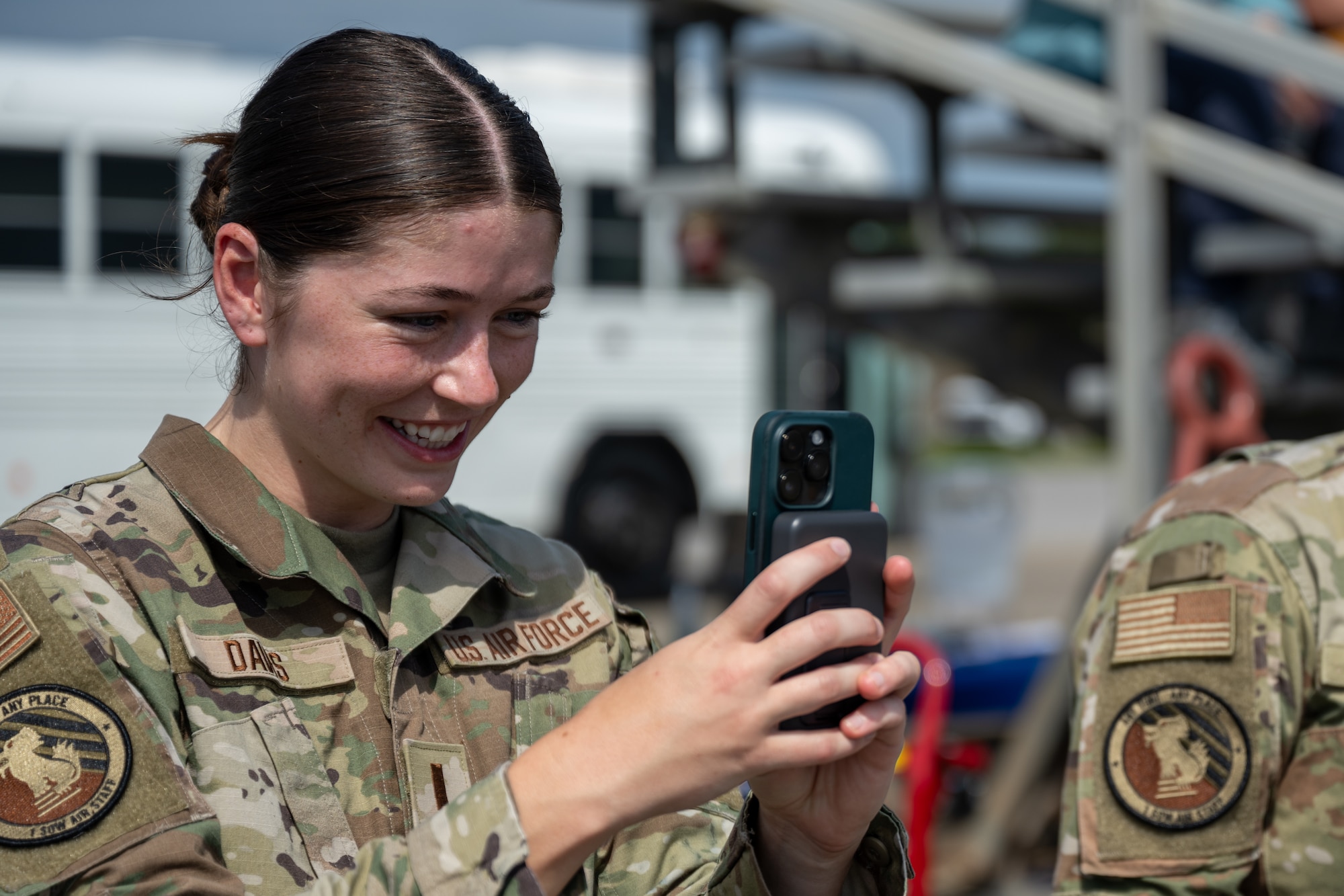 U.S. Air Force 2nd Lt. Makenna Davis,1st Special Operations Logistics Readiness Squadron assistant installation deployment officer, takes a photo of civic leaders trying on an armored vest and a helmet during the 94th Joint Civilian Orientation Conference at Hurlburt Field, Florida, Sept. 21, 2023. JCOC is the Department of Defense’s public liaison program, designed to provide American business and community leaders with a deeper understanding of the military by showcasing the rewards and challenges service members face both on and off the battlefield. (U.S. Air Force photo by Airman 1st Class Hussein Enaya)